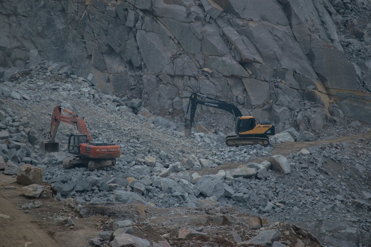 The Art of Drawing Readers In: Your attractive post title goes here Dynamic construction site featuring excavators working on rocky terrain.