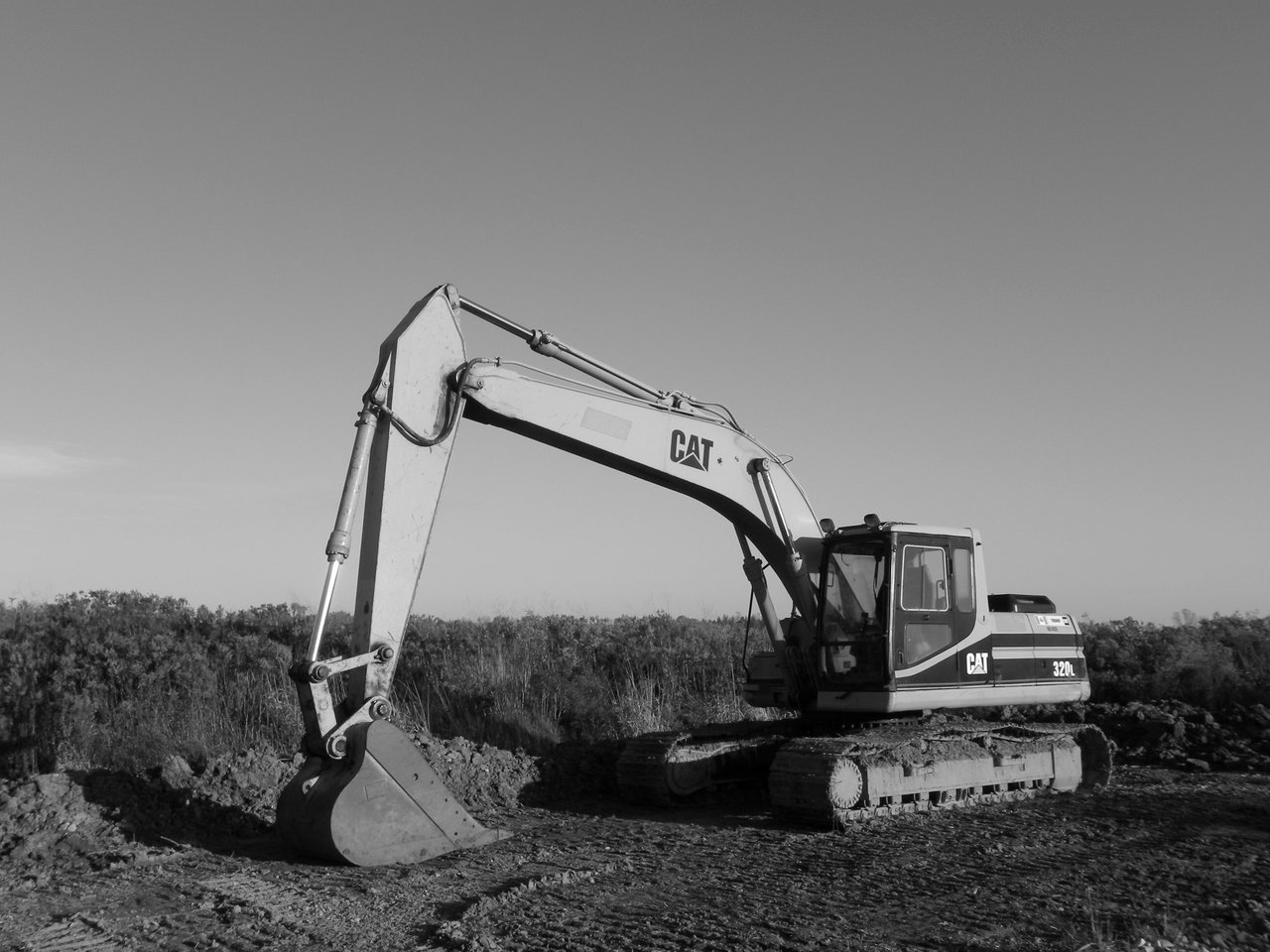 Home Monochrome image of an excavator at a construction site, ideal for industry themes.